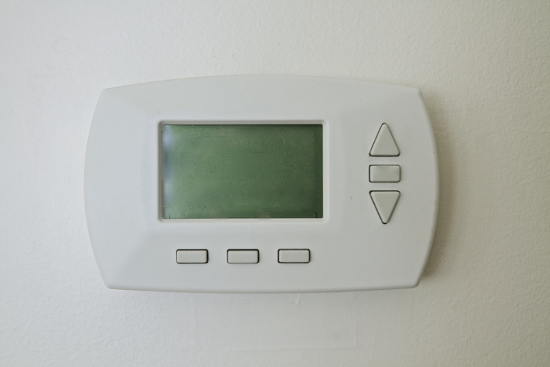 Why Is My Thermostat Blank? Photo of a blank thermostat mounted on the wall.